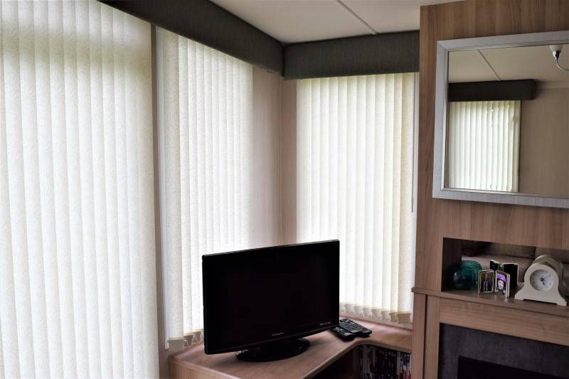 Vertical blinds nicely tucked behind the pelmets